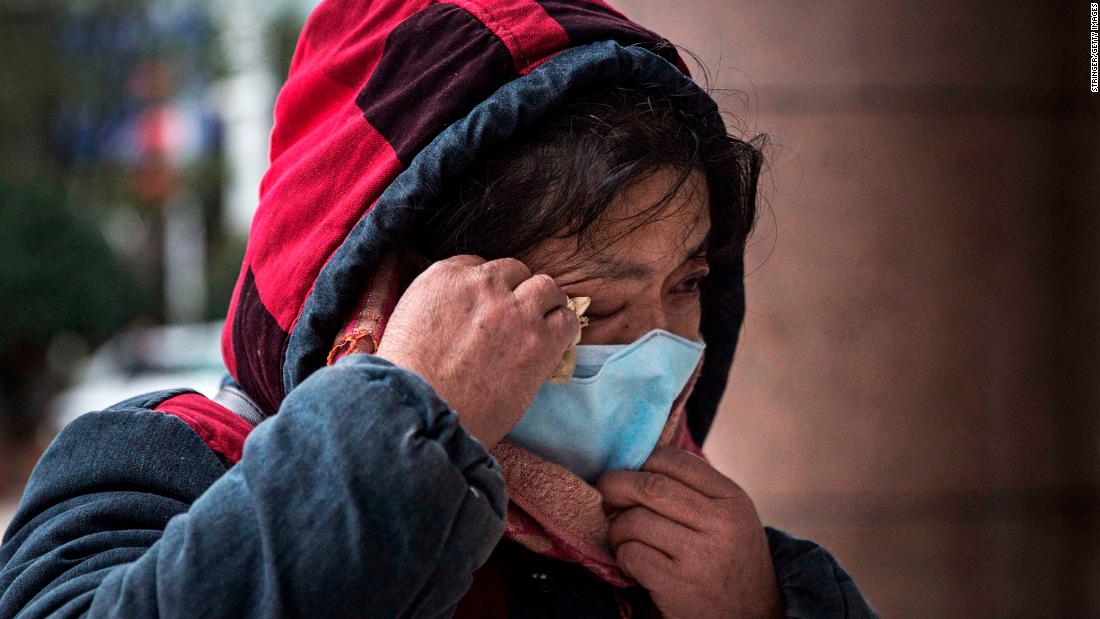 A woman grieves while paying tribute to Li at Li&#39;s hospital in Wuhan on February 7.