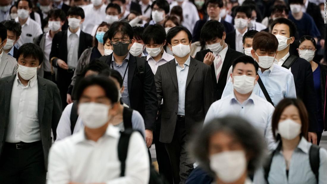 Commuters crowd a train station in Tokyo during the morning rush hour on May 26.